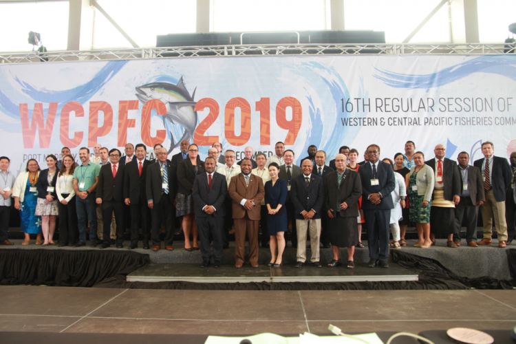 Group of people in front of banner for 16th regular session of the Western and Central Pacific Fisheries Commission (WCPFC16) 5 December 2019