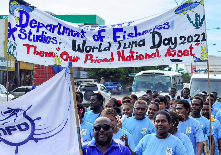 Students of School of Fisheries and Marine Studies at Solomon Islands National University march under banner in parade for World Tuna Day 2021. Photo Ronald Toito'ona.